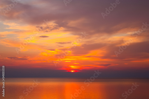 Background of colorful sky concept: Dramatic sunset with orange color sky and clouds.
