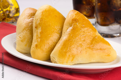 Syrian-Lebanese pie stuffed with meat called sfiha in a platter in white background photo