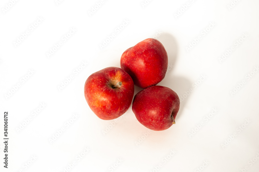 Red apples near a vase of lavender Red apples near a vase of lavender