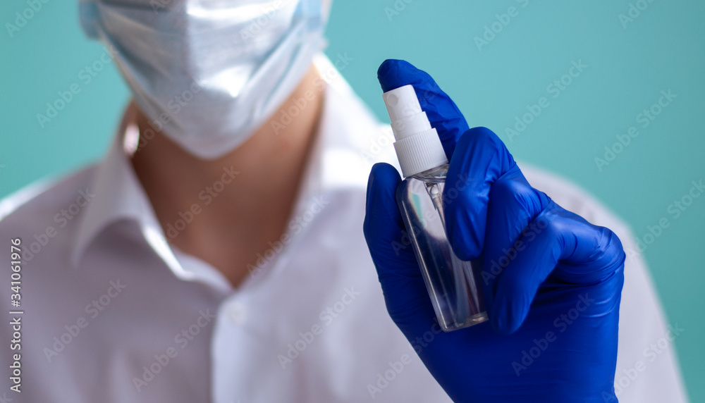 Bottle of antiseptic in hand Antibacterial spray for hands antiseptic. Hand antiseptic disinfection. Plastic bottle with clear body. Bottle of antiseptic in hand Antibacterial spray for hands antiseptic. Hand antiseptic disinfection. Plastic bottle with clear body.
