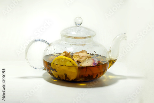hot tea with rose petals and lemon in a teapot