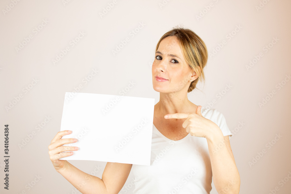 Beautiful woman with paper looking into the camera Beautiful woman with paper looking into the camera