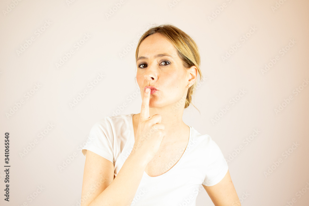 Beautiful woman making a gesture to the camera Beautiful woman making a gesture to the camera
