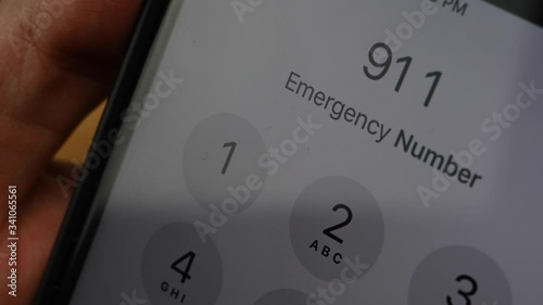 Hand Dials the number 911 on mobile phone
