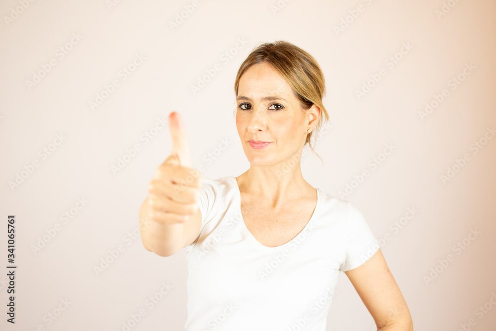 Beautiful woman making thumbs up to the camera Beautiful woman making thumbs up to the camera