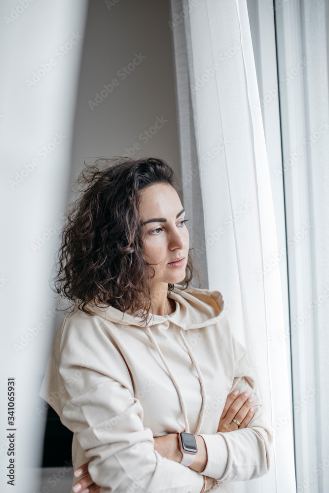 Portrait of pensive woman looking out of window Portrait of pensive woman looking out of window