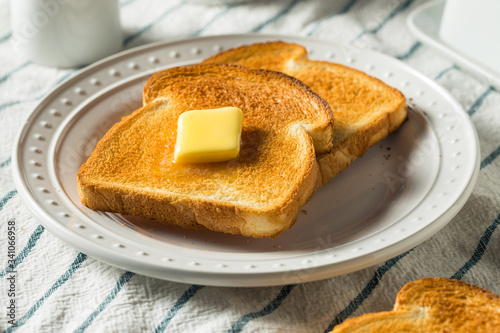 Fényképezés Homemade Warm Buttered Toast for Breakfast
