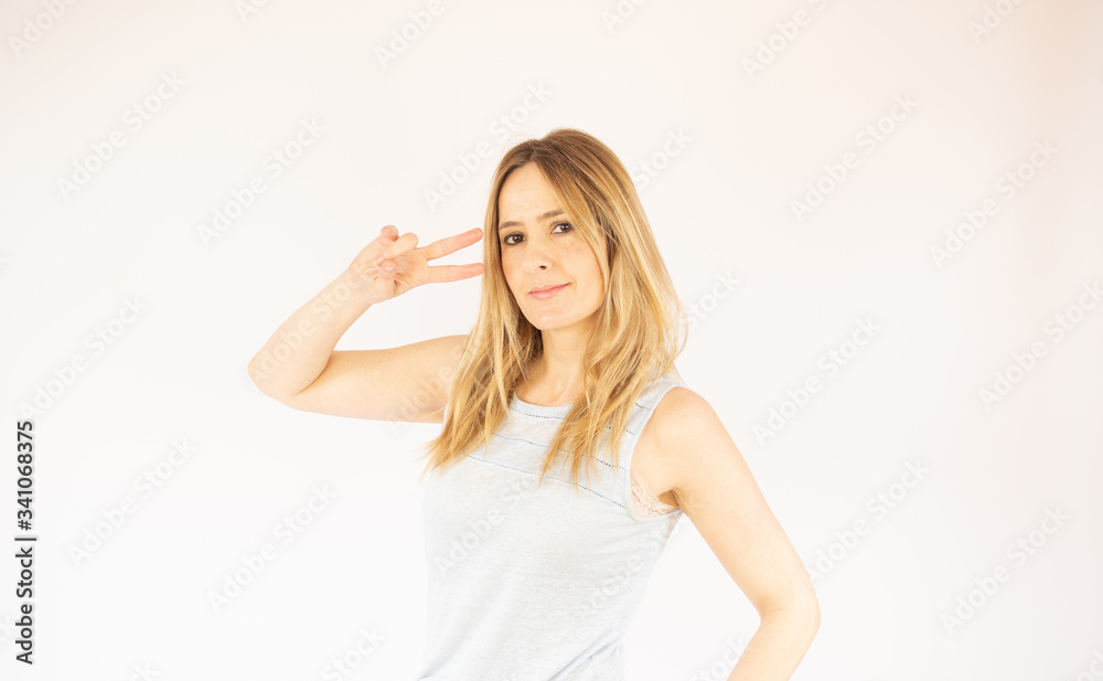Beautiful woman making a victory gesture Beautiful woman making a victory gesture