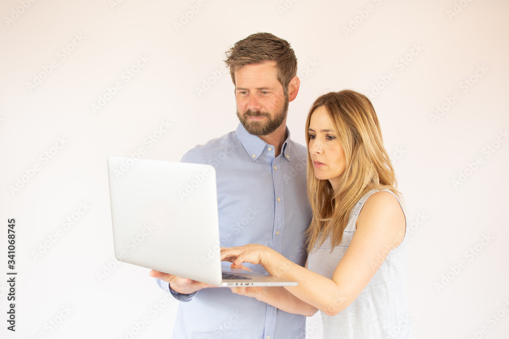 handsome couple is looking at their laptop handsome couple is looking at their laptop