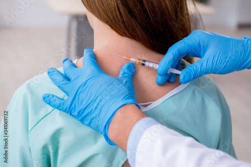 Bild auf Leinwand Young back injured woman visiting male doctor chiropractor