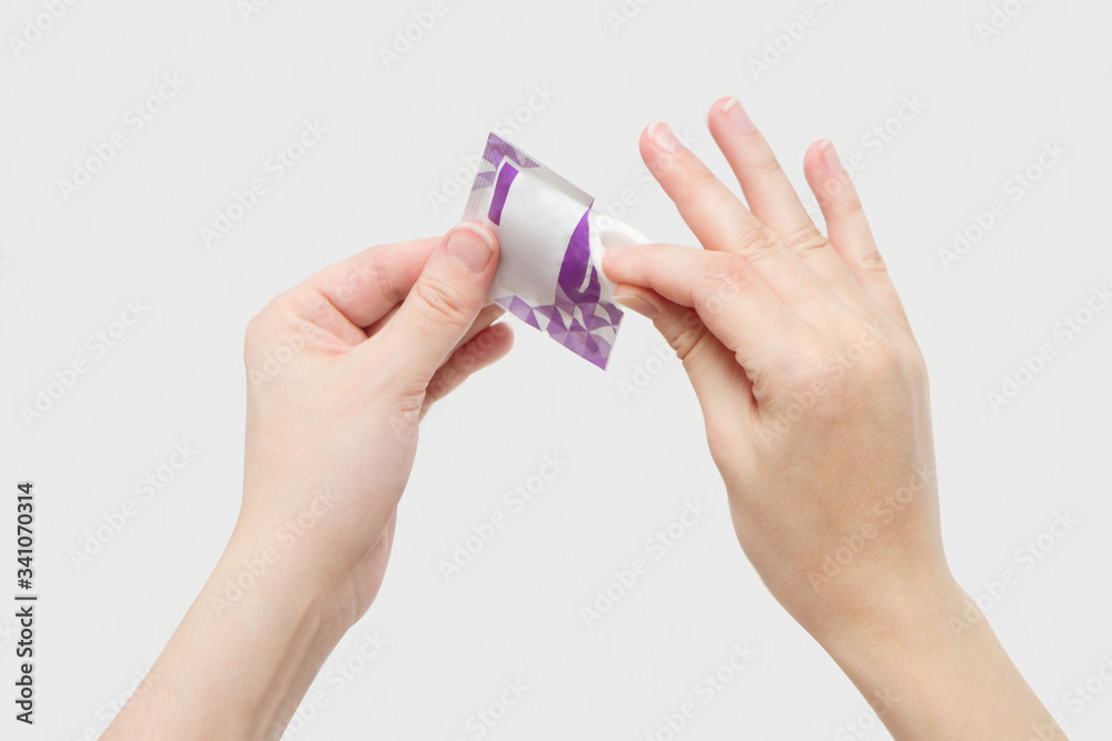 Fototapeta premium Coronavirus COVID-19. Alcohol pad is use for disinfection as first aid. Wet tissue epidemic prevention, antibacterial sterilization. Cleaning hands with alcohol-based hand sanitizing antiseptic wipes