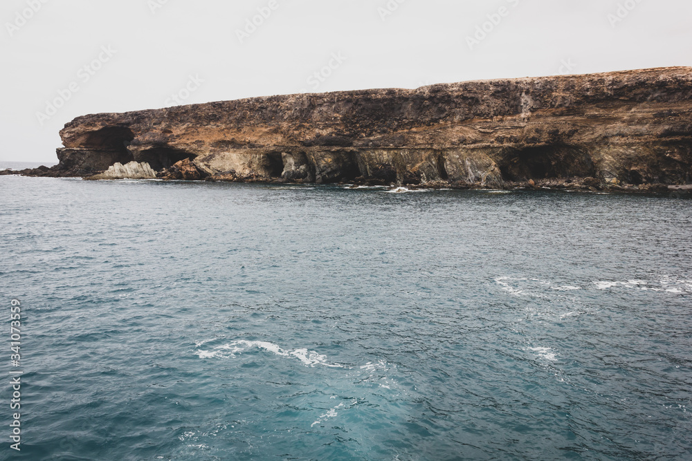 Popular Ajuy caves landscape by the sea on cloudy day in Fuerteventura island. Iconic tourism destination on Atlantic Ocean in Spain coast. Vintage effect applied