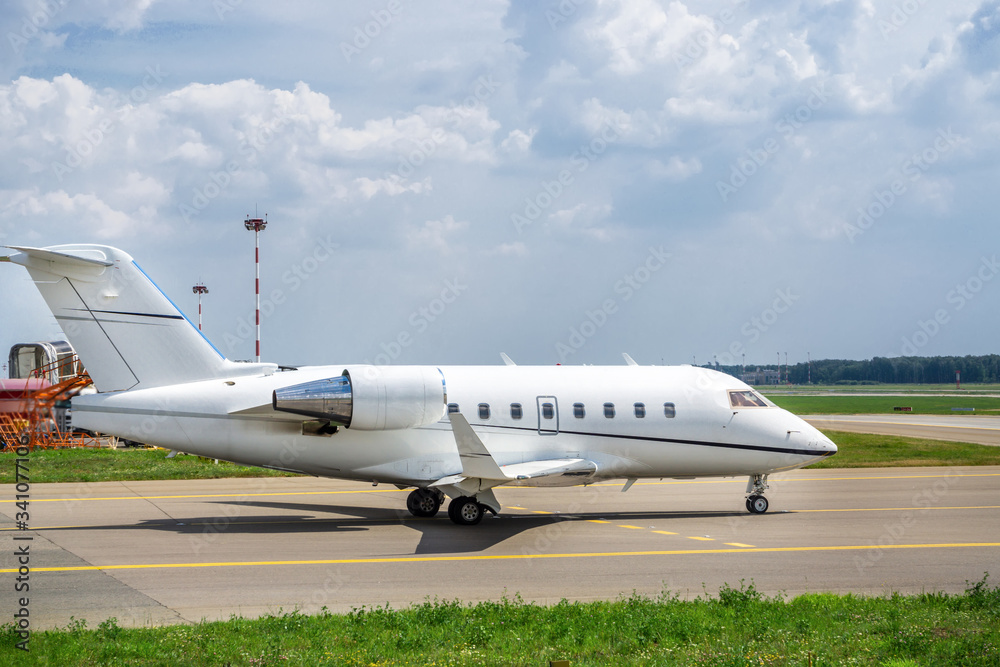 Business jet moves on taxiway to the runway Business jet moves on taxiway to the runway