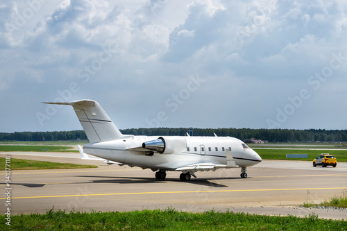 Airport follow me car guiding the business jet on the taxiway