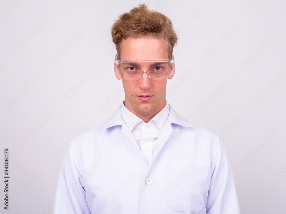 Young handsome Scandinavian man doctor against white background Young handsome Scandinavian man doctor against white background