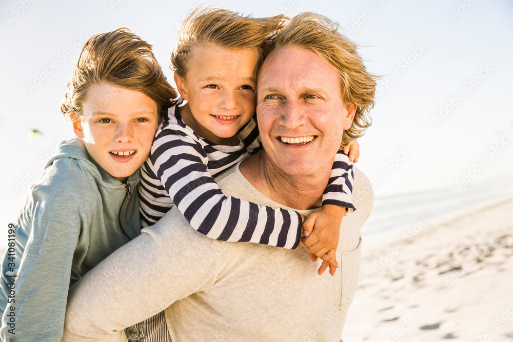 Happy father with two sons having fun on the beach Happy father with two sons having fun on the beach
