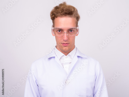 Young handsome Scandinavian man doctor against white background