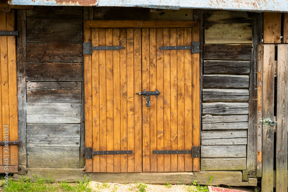 wooden gate with a bolt lock in an old farm shed wooden gate with a bolt lock in an old farm shed