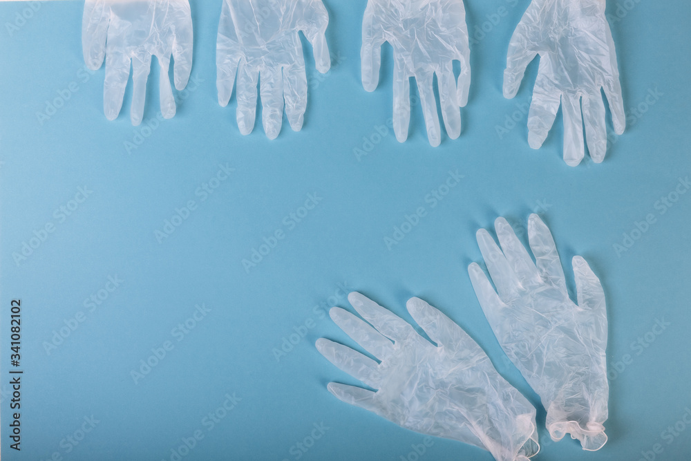 Whitte surgical gloves isolated on the blue background. Concept protect against infection or contamination Whitte surgical gloves isolated on the blue background. Concept protect against infection or contamination