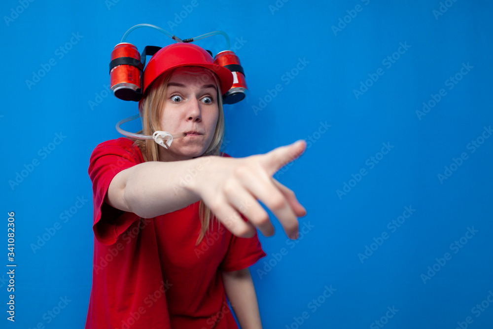 Obraz premium surprised funny girl a fan in a beer hat shows a finger at the camera, a shocked cheerleader is rooting for the team