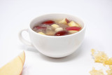 A bowl of white fungus soup with red apple, lotus seeds and red dates.