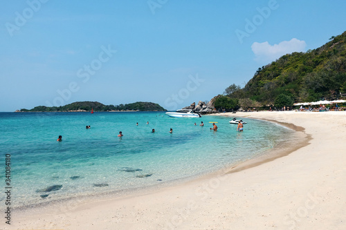 Fototapeta Naklejka Na Ścianę i Meble -  Tropical beach, white sand, turquoise sea, people swimming and relaxing. Pattaya Thailand March 2020          