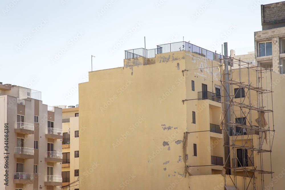 construction on a tall building taking place construction on a tall building taking place