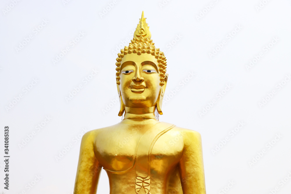 Statue of the Golden Buddha against the light sky.