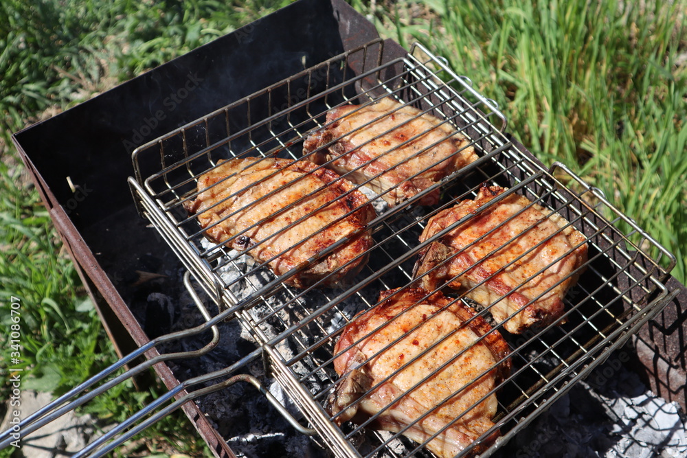 Pork steaks cooked on a charcoal grill outdoors