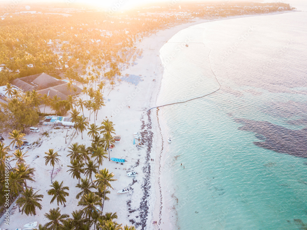 aerial view of a tropical beach in the caribbean with golden sunset