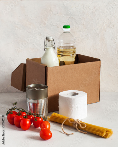 Cardboard box with food supplies for the period of quarantine isolation. Food delivery, donation. photo