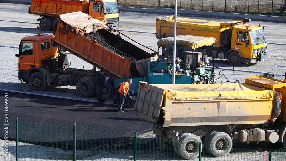 Road construction works with commercial equipment.