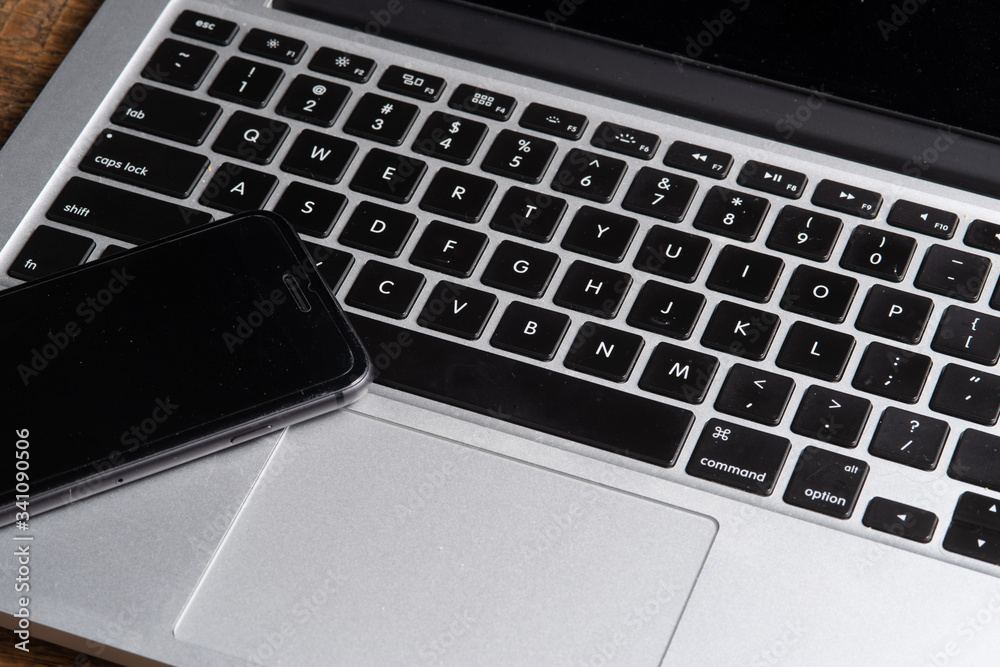laptop on the table with cell phone laptop on the table with cell phone