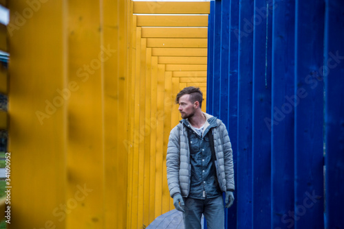 stylish traveler walking down blue and yellow tunnel in tallinn estonia photo