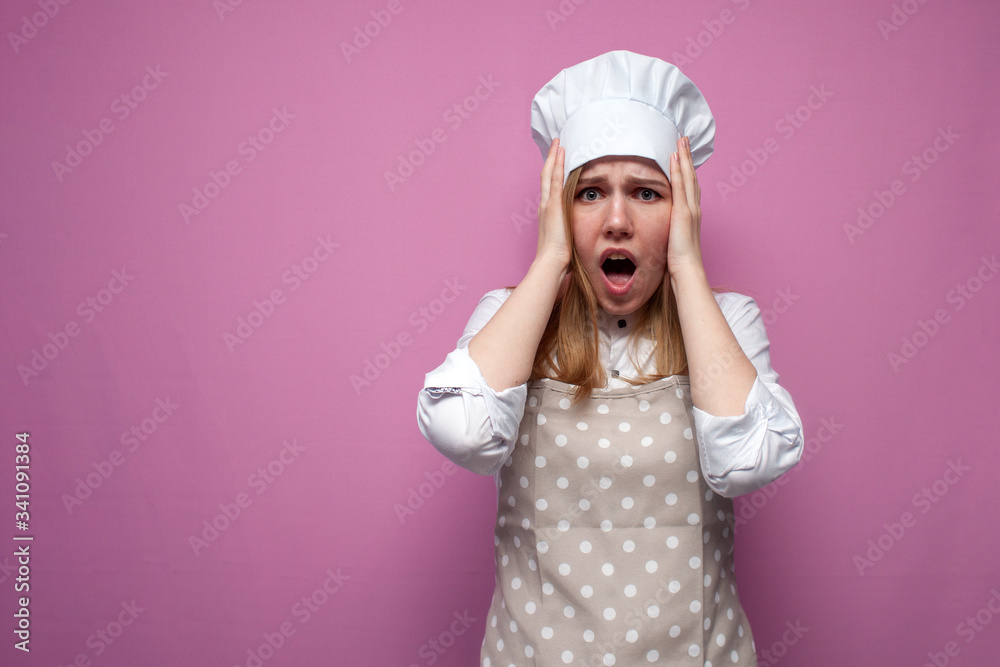 shocked girl cook in apron hold hands to head and scream on pink background, surprised woman housewife in kitchen clothes in stress shocked girl cook in apron hold hands to head and scream on pink background, surprised woman housewife in kitchen clothes in stress