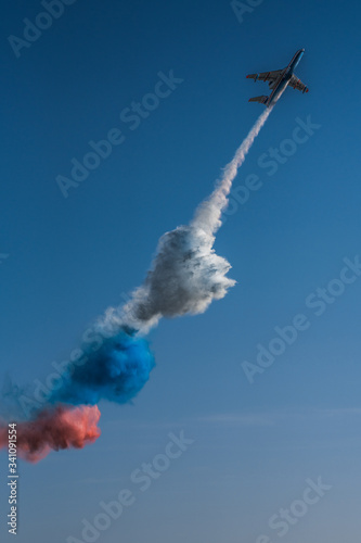 Zhukovskiy, Moscow Oblast, Russia, 08 28 2019: BE-200 multipurpose plane emits smoke in the colors of the flag of Russia