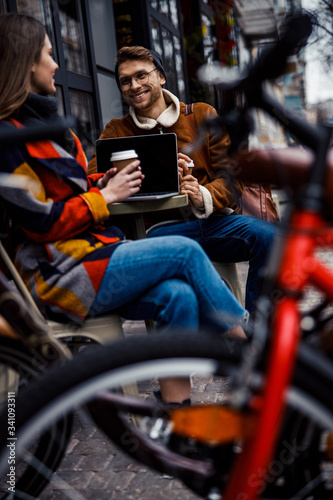 Cheerful couple meeting at the cafe table and talking stock photo