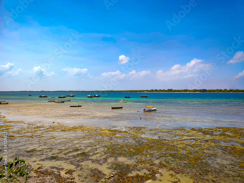 Low tide at Wasini island in Kenya, Africa. Wonderful view of the sea and small boats.