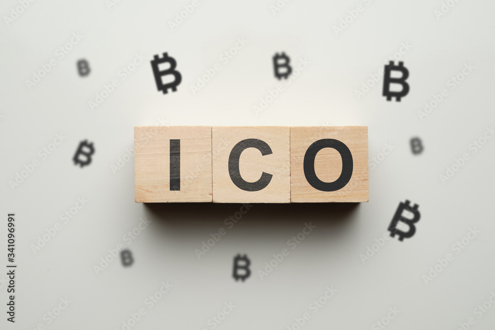 The concept of ico and cryptocurrency - wooden cubes with bitcoin. The concept of ico and cryptocurrency - wooden cubes with bitcoin.