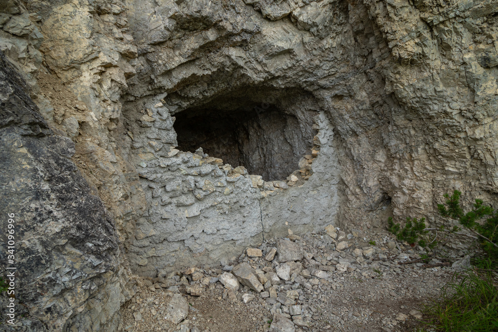 Demolished entrance to a small cave in the Dolomites Demolished entrance to a small cave in the Dolomites