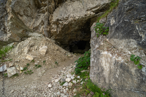 entrance to a small cave in the dolomites