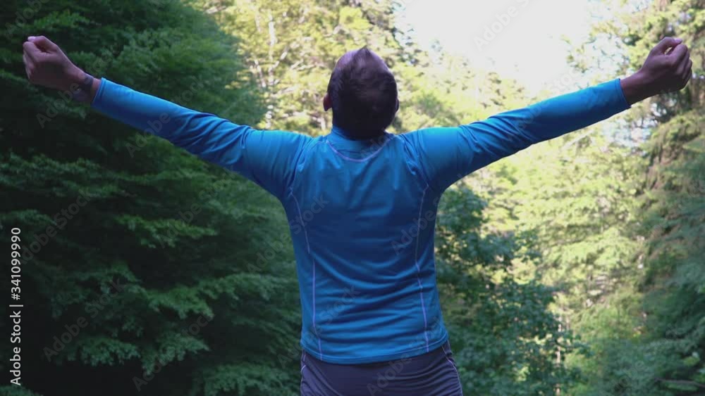 Man standing in the forest and stretching his muscles
Man standing in the forest and stretching his muscles