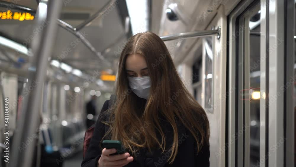 young female in protective medical mask in empty public transport. covid-19 coronavirus pandemic health protection concept young female in protective medical mask in empty public transport. covid-19 coronavirus pandemic health protection concept