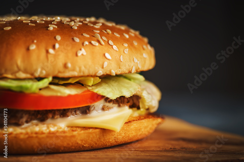 Fresh homemade burger or hamburger, fast food, macro photo, copy space.