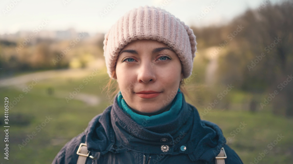 Portrait of young pretty calm girl looks at camera, blurred spring nature background. Portrait of young pretty calm girl looks at camera, blurred spring nature background.