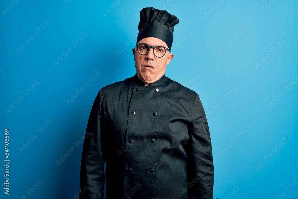 Middle age handsome grey-haired chef man wearing cooker uniform and hat In shock face, looking skeptical and sarcastic, surprised with open mouth Middle age handsome grey-haired chef man wearing cooker uniform and hat In shock face, looking skeptical and sarcastic, surprised with open mouth