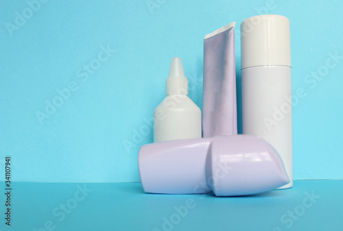 White bottle with Body antiperspirant deodorant roll-on on blue background.