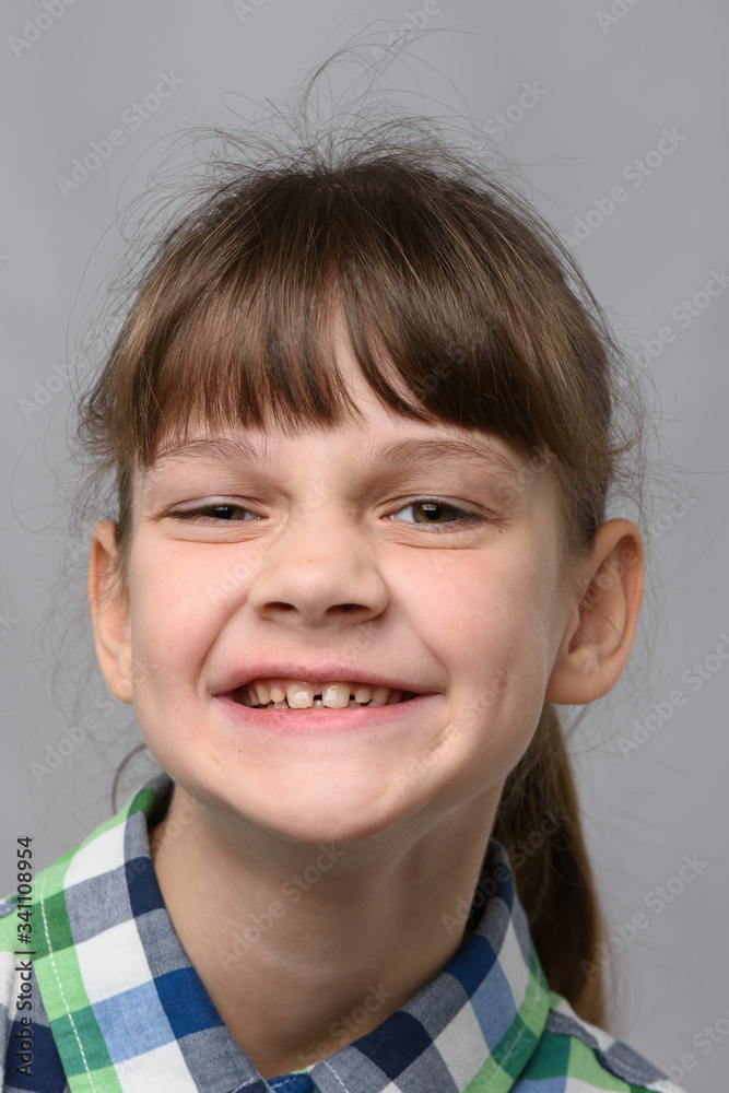 Portrait of a funny smiling ten-year-old girl of European appearance, close-up Portrait of a funny smiling ten-year-old girl of European appearance, close-up