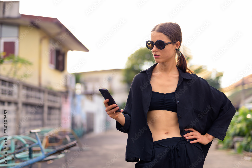 Portrait of young beautiful woman in the city streets outdoors Portrait of young beautiful woman in the city streets outdoors