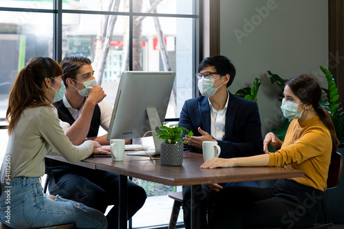Businessman and women working together in public places on a day that covid 19 virus are epidemics. They wear surgical masks to prevent the outbreak of corona virus, influenza or dust allergy.